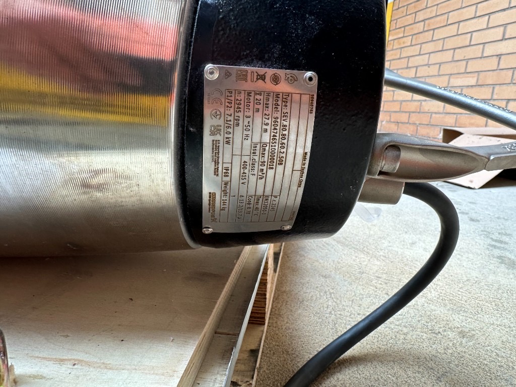 Close-up of the Grundfos SEV.80.80.60.2.50B nameplate showing 6.0 kW power, IP68 rating and flow specifications during the Queen Victoria Apartments pump replacement