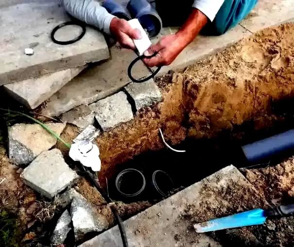 Plumber fitting a new gasket on underground bore pump drop-pipe connections during a seal repair on an Adelaide property